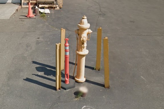 Metal bollards protecting hydrant