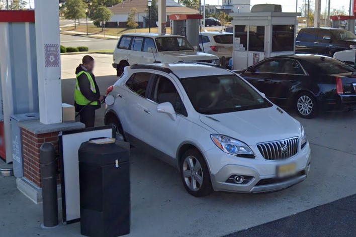 Employees pumping gas